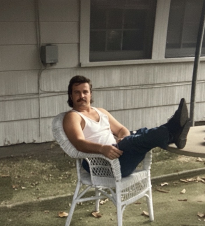 Roger Smith sitting outside in the 90s